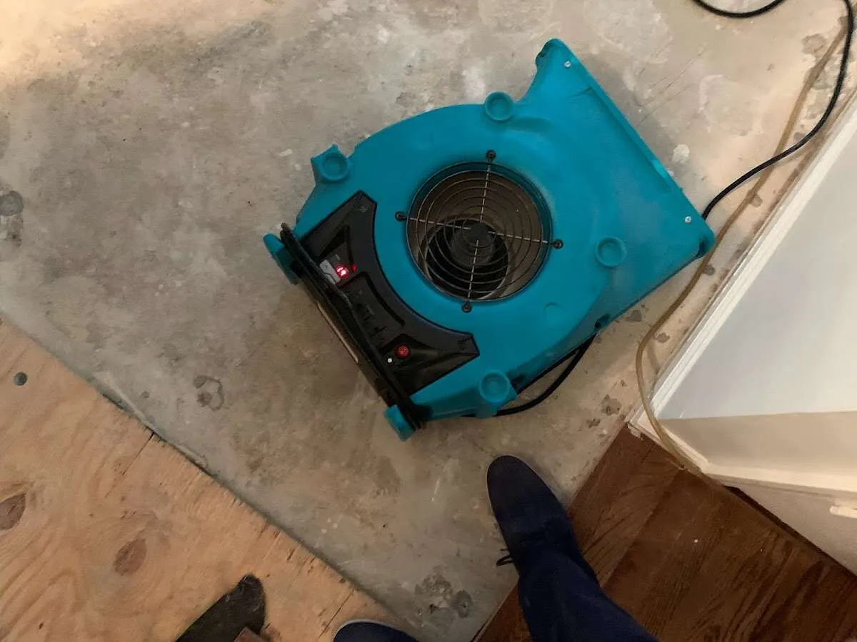 Air mover drying subfloor during Leak Detection & Repair in Augusta